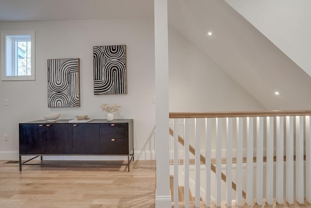 interior space featuring recessed lighting, vaulted ceiling, and light wood-style flooring