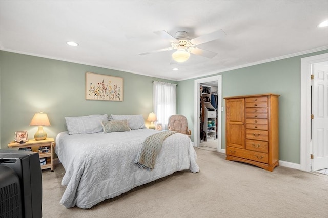 bedroom featuring light carpet, a ceiling fan, baseboards, ornamental molding, and a closet