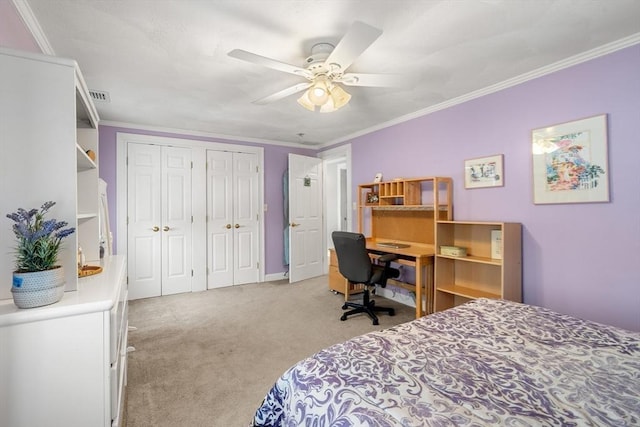 bedroom featuring light carpet, multiple closets, visible vents, and crown molding