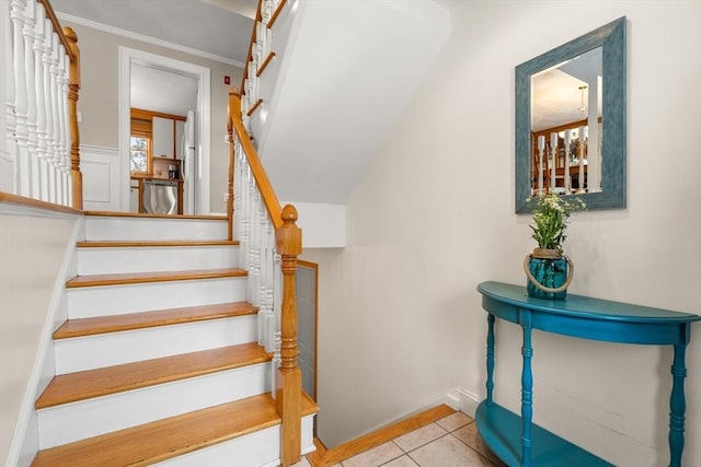 stairway with baseboards and tile patterned floors