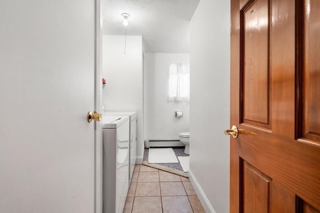 bathroom featuring tile patterned flooring, a baseboard heating unit, baseboards, and independent washer and dryer