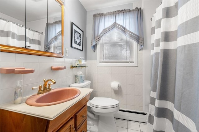 full bath featuring toilet, tile walls, vanity, baseboard heating, and tile patterned floors