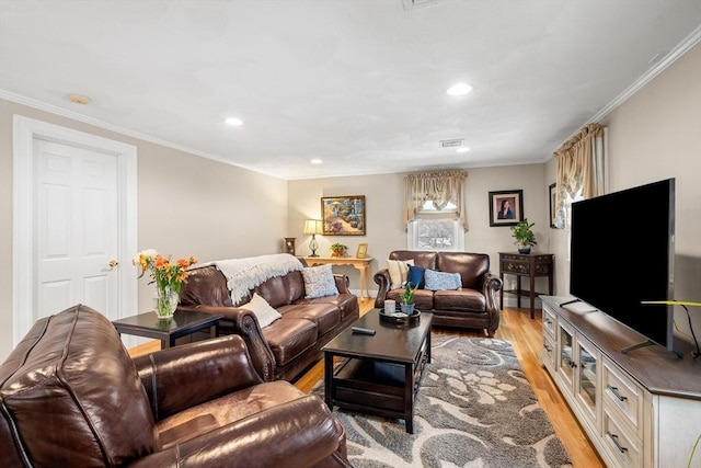 living area featuring light wood finished floors, visible vents, crown molding, and recessed lighting