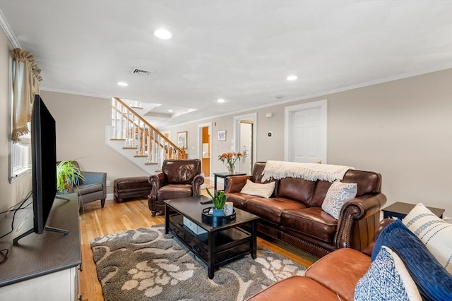 living area featuring crown molding, recessed lighting, visible vents, stairway, and light wood-style floors