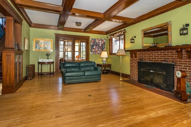 living room featuring light wood-style flooring, a fireplace, beamed ceiling, and coffered ceiling