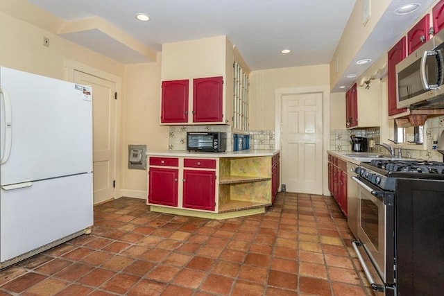 kitchen with recessed lighting, a sink, light countertops, appliances with stainless steel finishes, and tasteful backsplash