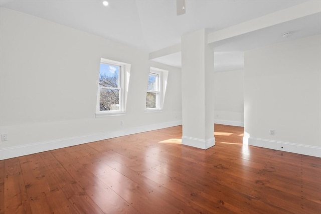 empty room featuring baseboards and hardwood / wood-style floors