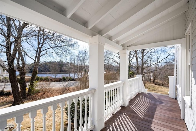 deck with a porch and a water view