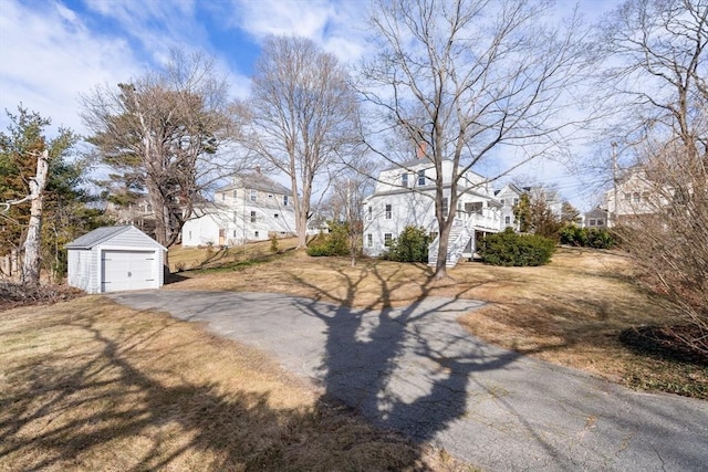 view of street with aphalt driveway, a residential view, and stairway