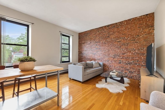 17 Dwight Unit 3, Boston, MA 02118 - living area with brick wall, light wood finished floors, and a baseboard heating unit
