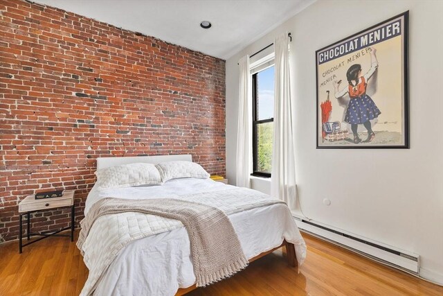 17 Dwight Unit 3, Boston, MA 02118 - bedroom with baseboard heating, wood finished floors, and brick wall