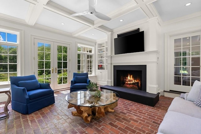 26 Longmeadow Dr, Westwood, MA 02090 - living room featuring coffered ceiling, a lit fireplace, french doors, crown molding, and brick flooring