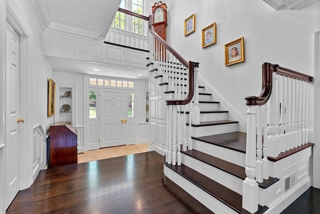 26 Longmeadow Dr, Westwood, MA 02090 - entryway with wood finished floors, stairs, crown molding, and a decorative wall