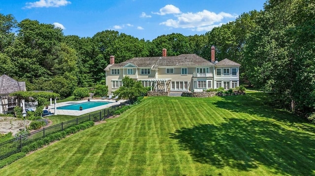 26 Longmeadow Dr, Westwood, MA 02090 - back of house with a fenced backyard, a chimney, and french doors