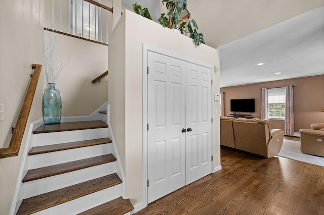 staircase featuring wood finished floors, recessed lighting, and baseboards