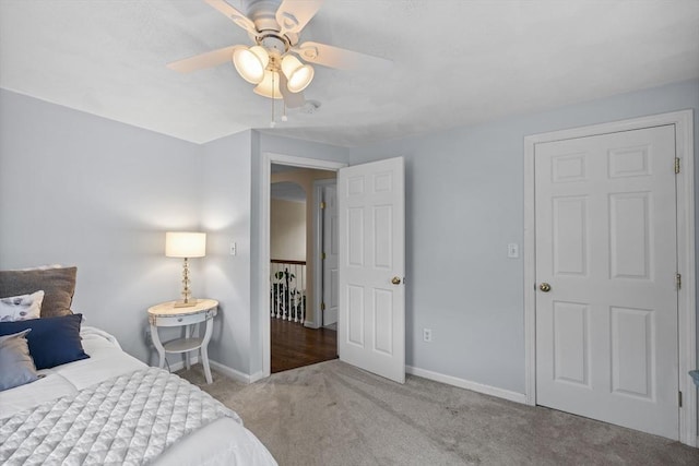 carpeted bedroom with baseboards and ceiling fan