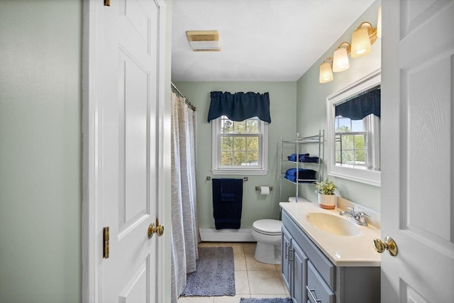 bathroom featuring vanity, toilet, and tile patterned flooring