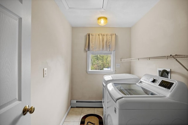 washroom featuring a baseboard heating unit, washing machine and clothes dryer, baseboards, and light tile patterned floors