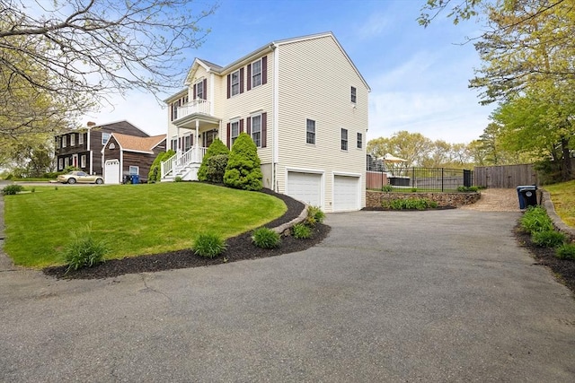 view of side of property with a garage and driveway