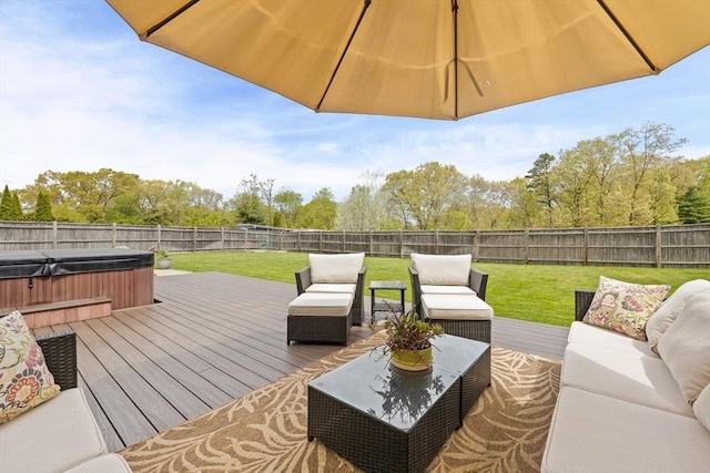 deck featuring a covered hot tub and an outdoor living space