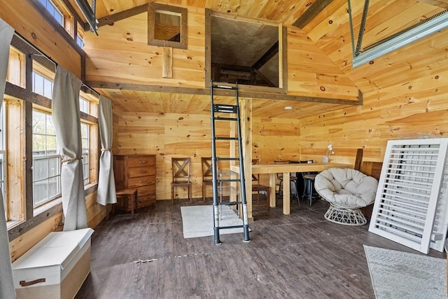 unfurnished room featuring wood walls, wood ceiling, wood finished floors, and vaulted ceiling