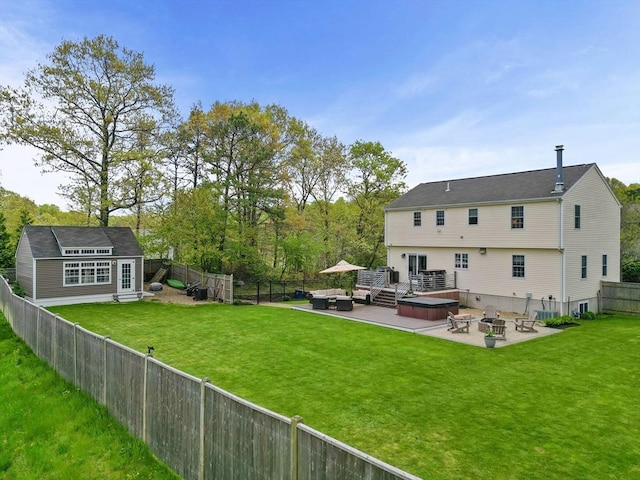 rear view of property with a patio area, a hot tub, an outdoor living space with a fire pit, an outdoor structure, and cooling unit