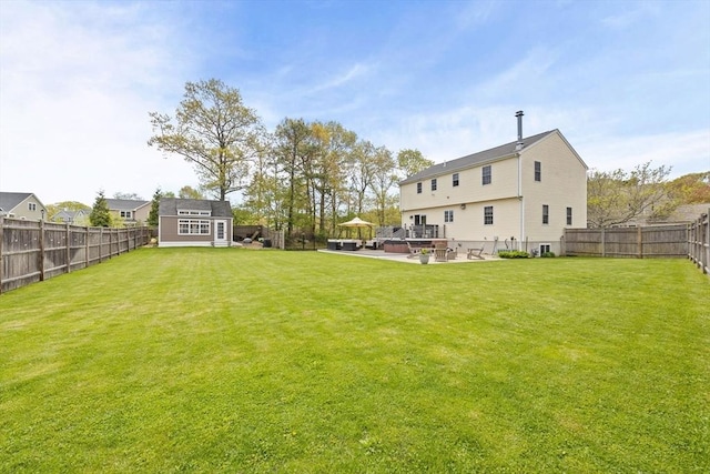 view of yard featuring a patio and an outbuilding