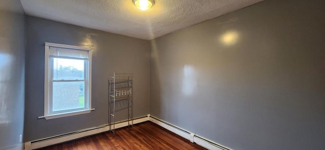 empty room featuring a textured ceiling and dark wood-type flooring