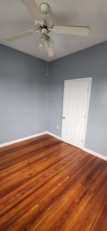 unfurnished bedroom with ceiling fan, baseboards, and wood finished floors