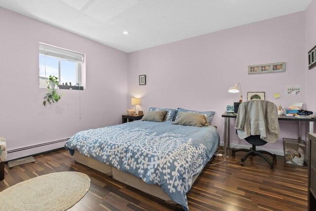 bedroom with baseboard heating, wood finished floors, recessed lighting, and a desk
