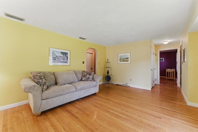 31 Fallston St, Springfield, MA 01119 - living room featuring arched walkways, light wood-type flooring, and baseboards