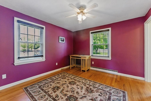 31 Fallston St, Springfield, MA 01119 - empty room featuring a baseboard heating unit, wood finished floors, and baseboards