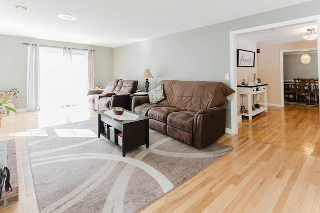 living room featuring baseboards and wood finished floors