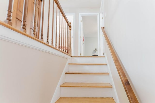 stairway featuring wood finished floors