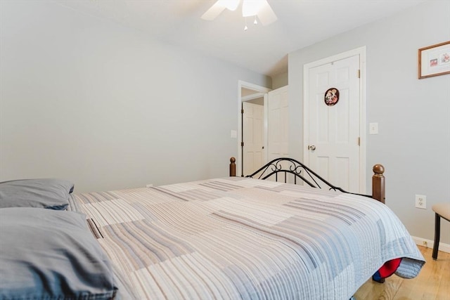 bedroom with light wood-style floors, baseboards, and a ceiling fan