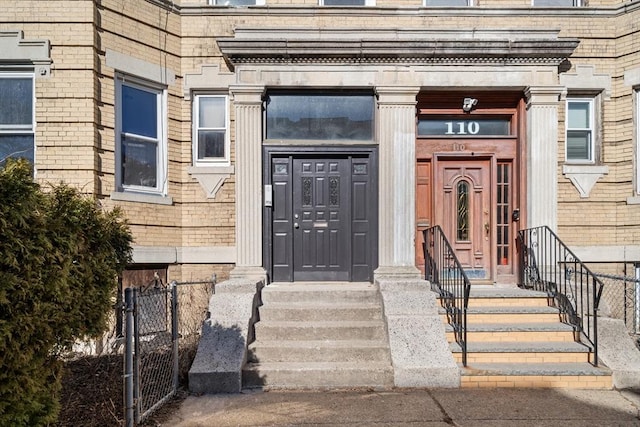 doorway to property with brick siding