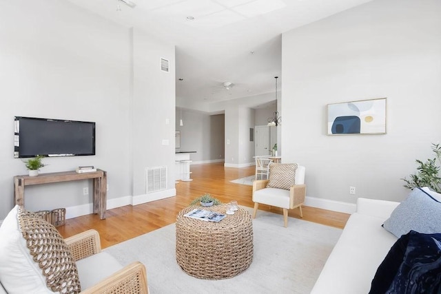 living room with wood finished floors, baseboards, and a ceiling fan