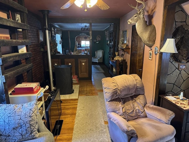 living room with ceiling fan and light wood-type flooring