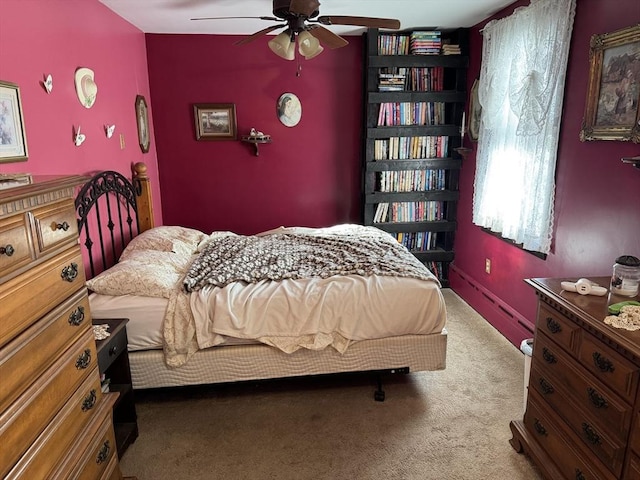 carpeted bedroom featuring ceiling fan and baseboard heating