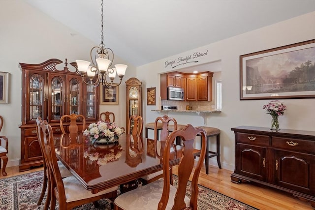 31 Shaker Hill Rd Unit 31, Hooksett, NH 03106 - dining room featuring a chandelier, light wood-type flooring, and vaulted ceiling