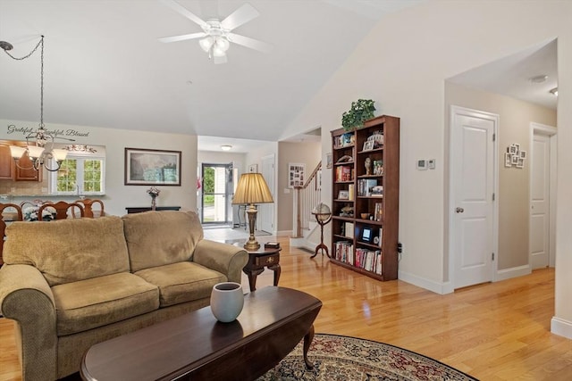 31 Shaker Hill Rd Unit 31, Hooksett, NH 03106 - living area with light wood-type flooring, stairs, a chandelier, healthy amount of natural light, and vaulted ceiling