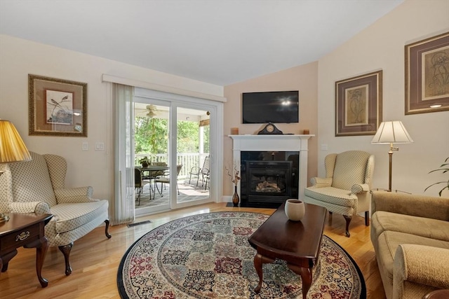 31 Shaker Hill Rd Unit 31, Hooksett, NH 03106 - living area with vaulted ceiling, light wood-type flooring, and a glass covered fireplace