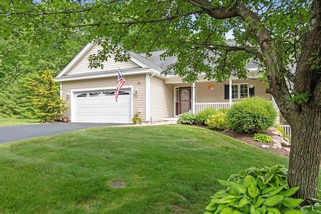 31 Shaker Hill Rd Unit 31, Hooksett, NH 03106 - view of front facade with covered porch, asphalt driveway, a front yard, and an attached garage