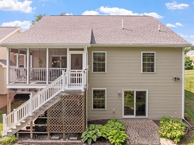 31 Shaker Hill Rd Unit 31, Hooksett, NH 03106 - back of property with a sunroom, roof with shingles, and a patio