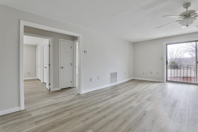 unfurnished room featuring light wood-style flooring, baseboards, visible vents, and ceiling fan