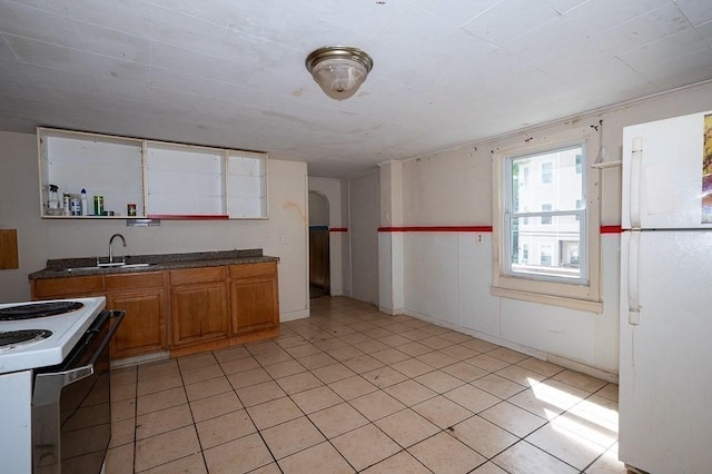 135 Elm St, Southbridge, MA 01550 - kitchen featuring white appliances, brown cabinets, light tile patterned flooring, open shelves, and dark countertops