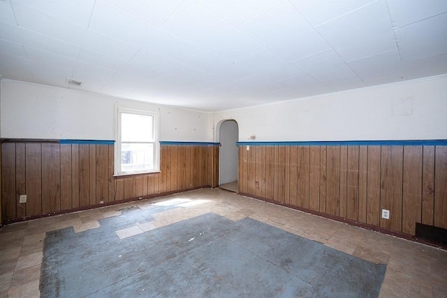 135 Elm St, Southbridge, MA 01550 - empty room with wood walls, wainscoting, and arched walkways
