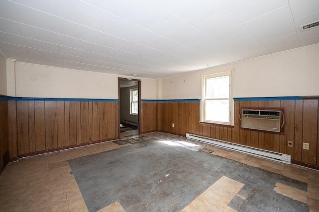 135 Elm St, Southbridge, MA 01550 - unfurnished room with a baseboard heating unit, a wainscoted wall, a wall mounted AC, plenty of natural light, and wood walls