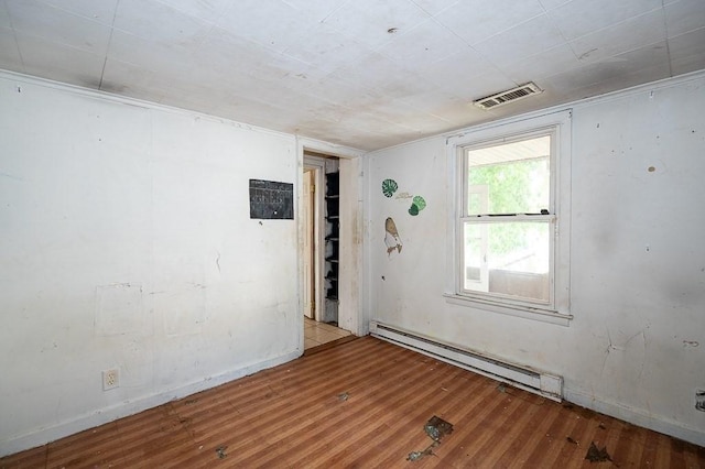 135 Elm St, Southbridge, MA 01550 - spare room featuring a baseboard heating unit and wood finished floors