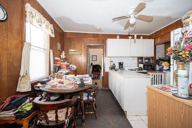 135 Elm St, Southbridge, MA 01550 - kitchen with a ceiling fan, ornamental molding, light countertops, black microwave, and white cabinetry